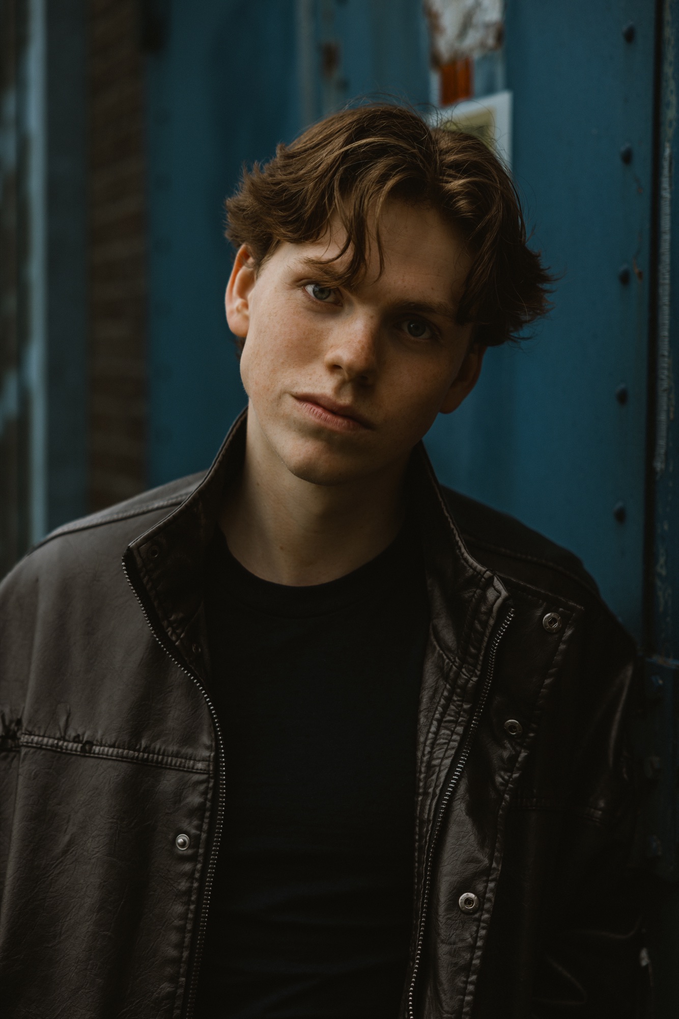 Senne in a leather jacket with a soft head tilt