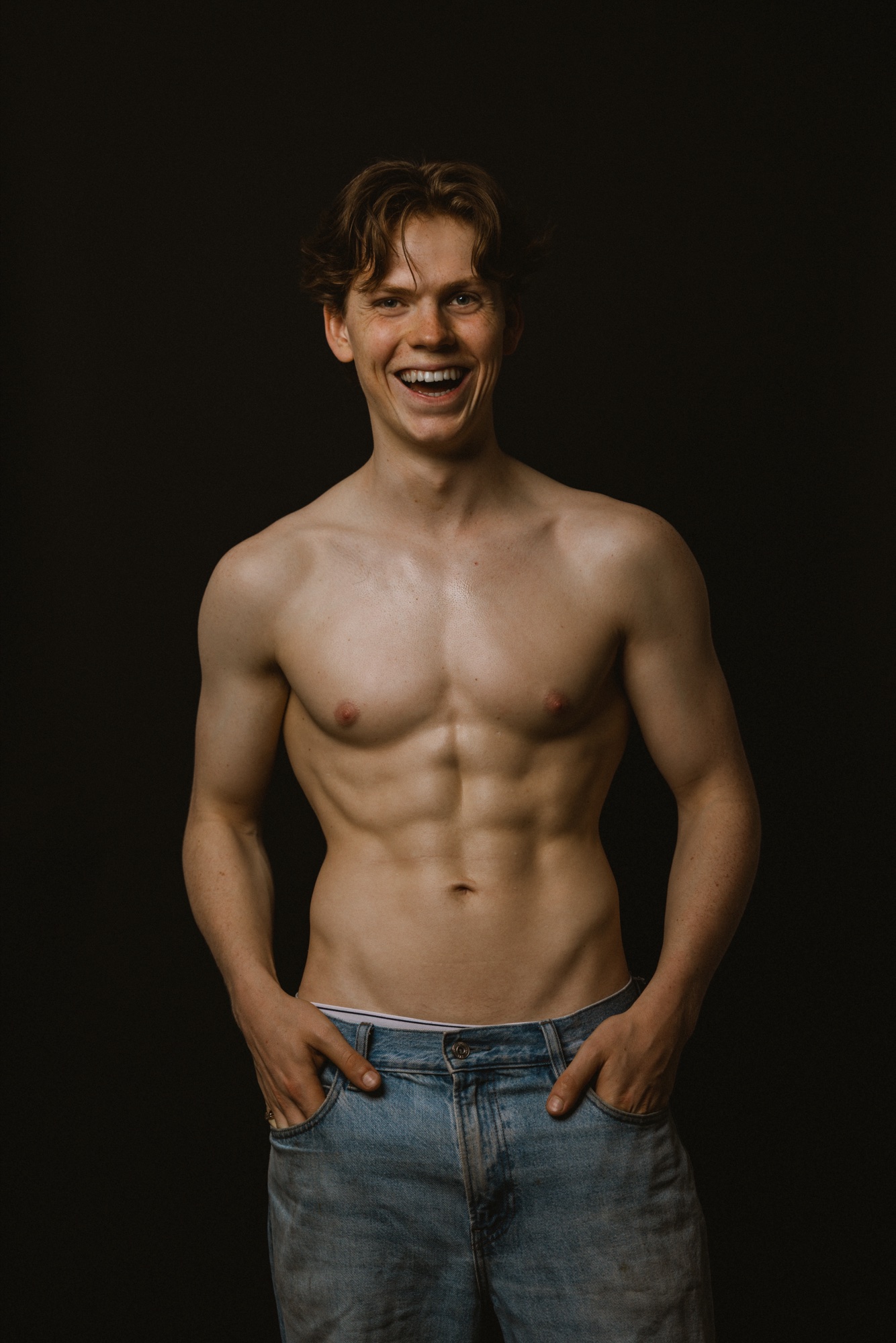 Senne laughing in the studio, hands in his pockets